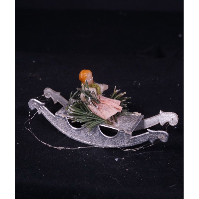 Antique Dresden cardboard, girl/wax on a sledge, size: 12 X 5 cm.