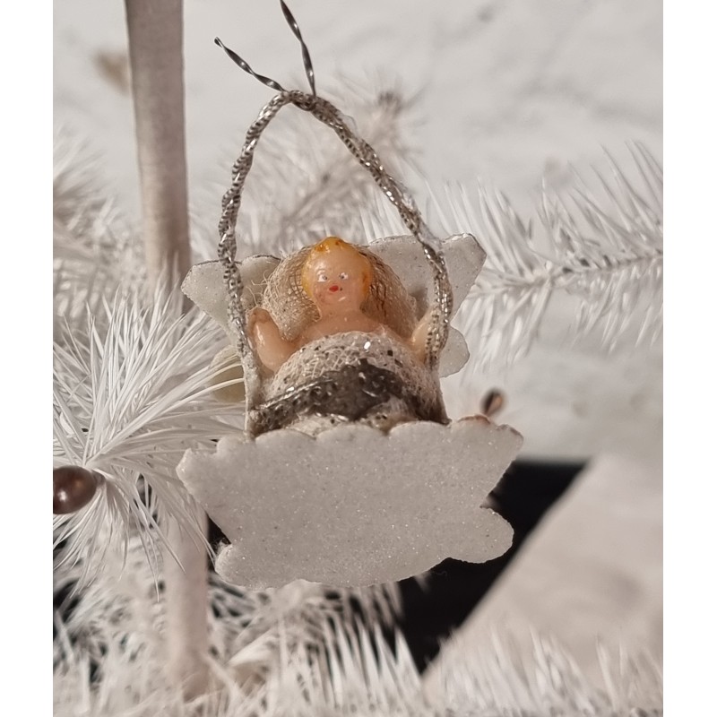 Antique cardboard ornament/Mica with wax doll in cradle, size: 4,5 x 3 cm.