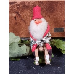 Old pinecone elf on a sledge with boots, h: 9 cm.