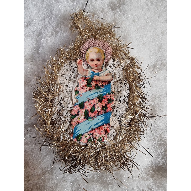 Antique tinsel ornament, child in a cradle, h: 12 cm.