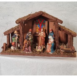 Old nativity in wood with bisquit figures, size: 39x13x23 cm.