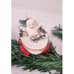 Snowchild in pine cone wagon, size: 8 x 3,5 cm.