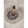 Antique reflector with an ornament in the middle, h: 6 cm.